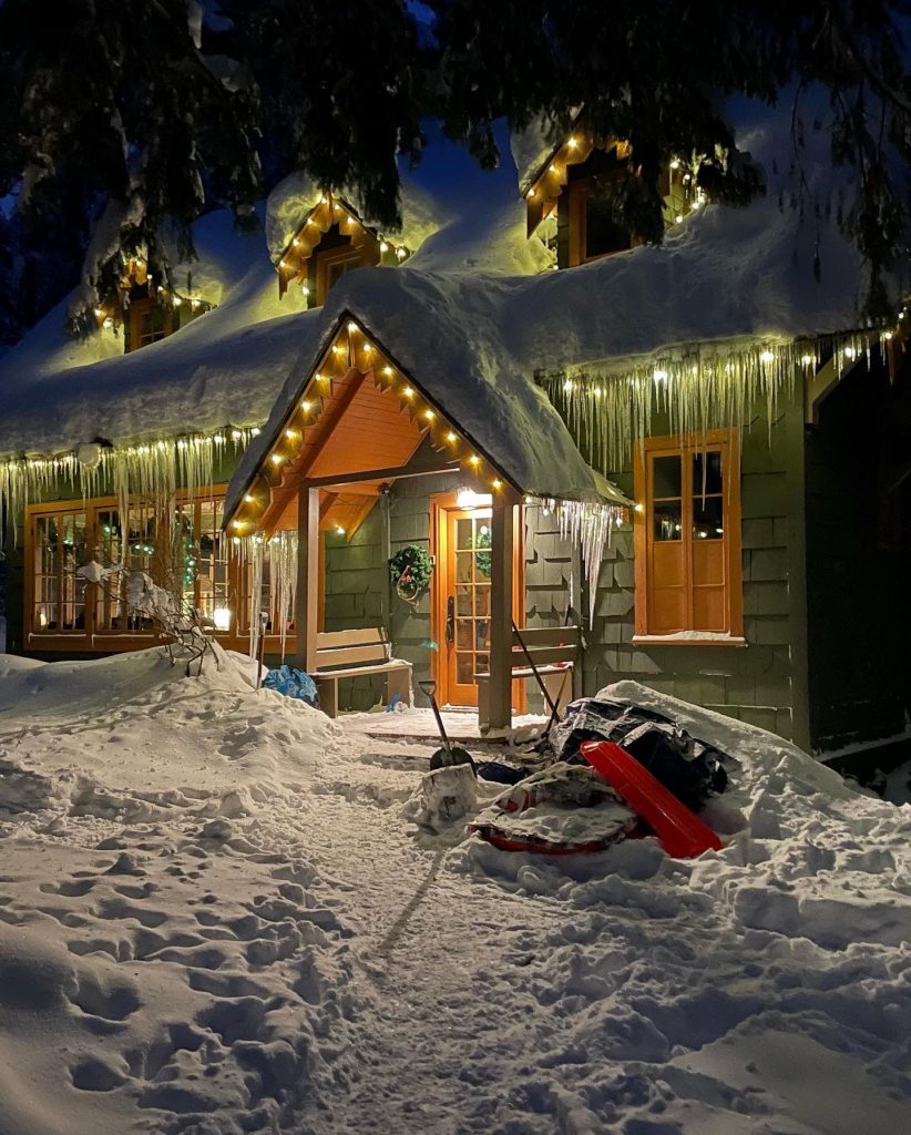 Paradise Trail Lodge lit up on a snowy evening